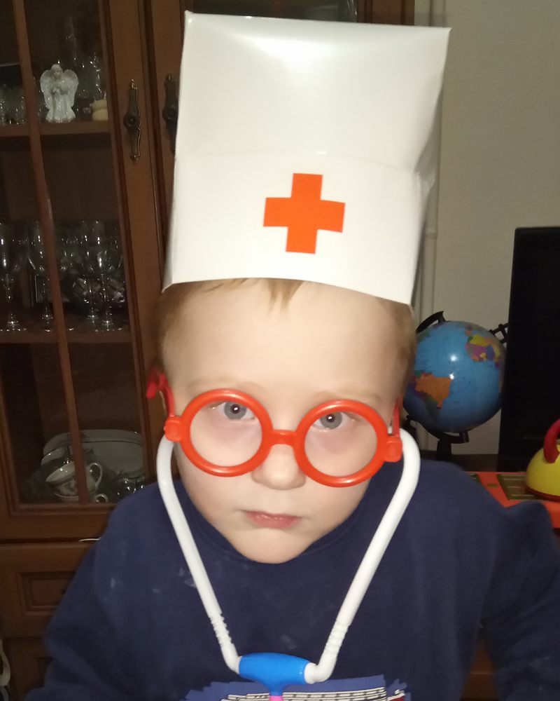 Bogdan in a paper doctor's cap and toy glasses
