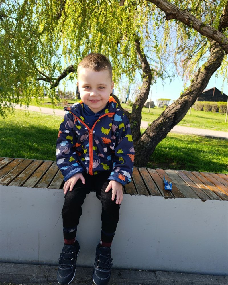 Damir sitting on a bench in a park