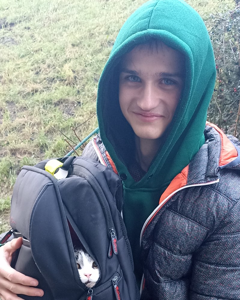 Timur with his cat in a backpack
